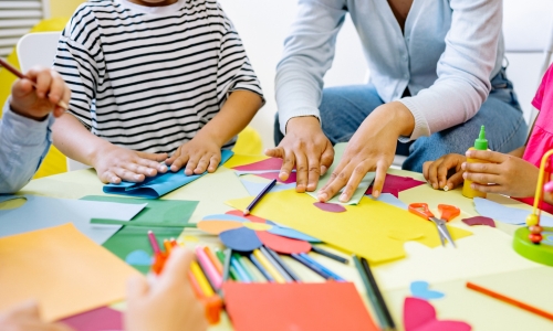 Children and adults doing arts and crafts activities